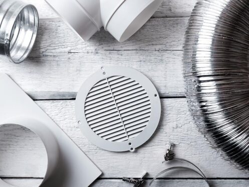 Wooden platform showcasing HVAC duct accessories by Omni Home Comfort.