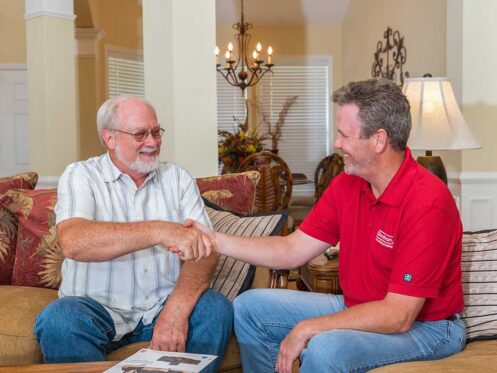Comfort Advisor from Omni Home Comfort shaking hands with a member after successful HVAC equipment installation